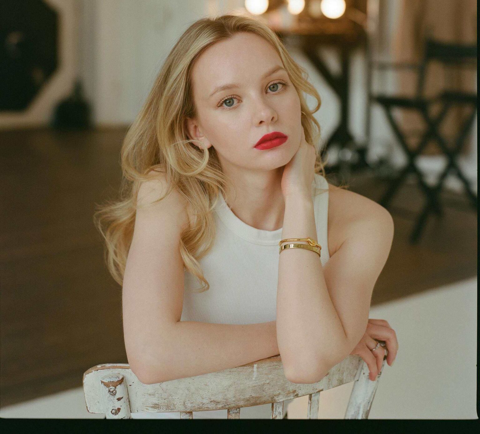 Woman with blonde hair sitting and thinking deeply