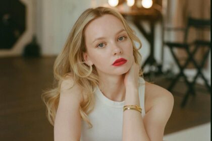 Woman with blonde hair sitting and thinking deeply