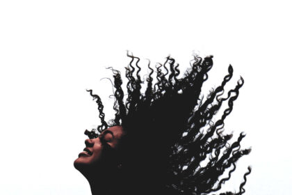 Girl enjoying flipping her textured hair in the air