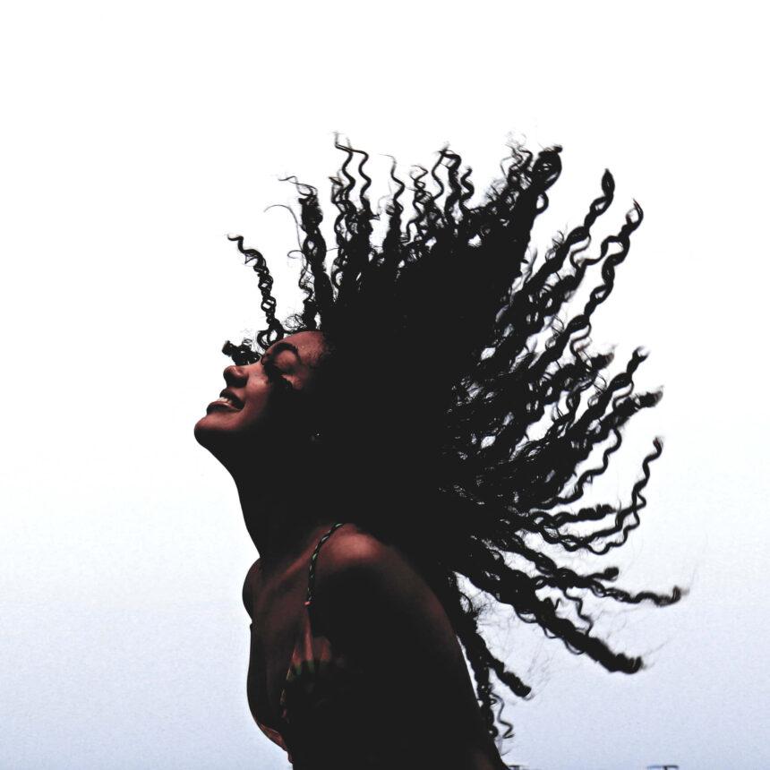 Girl enjoying flipping her textured hair in the air