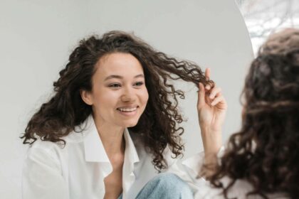 Lady smiling while looking at herself in the mirror