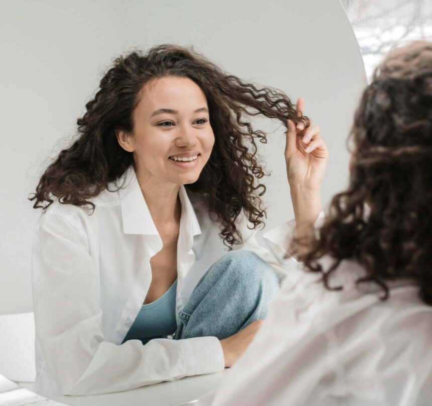 Lady smiling while looking at herself in the mirror